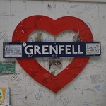 Grenfell heart shaped logo on a wall in the style of a London Underground sign